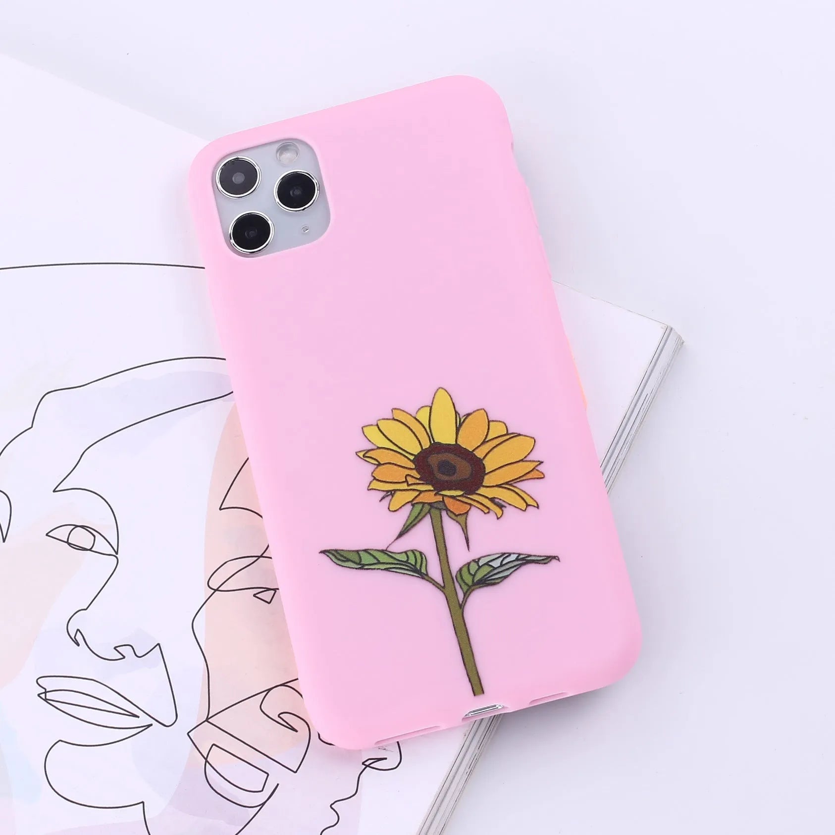 Slim TPU mobile phone case for iPhone on a table, showing one of 14 available colour options.