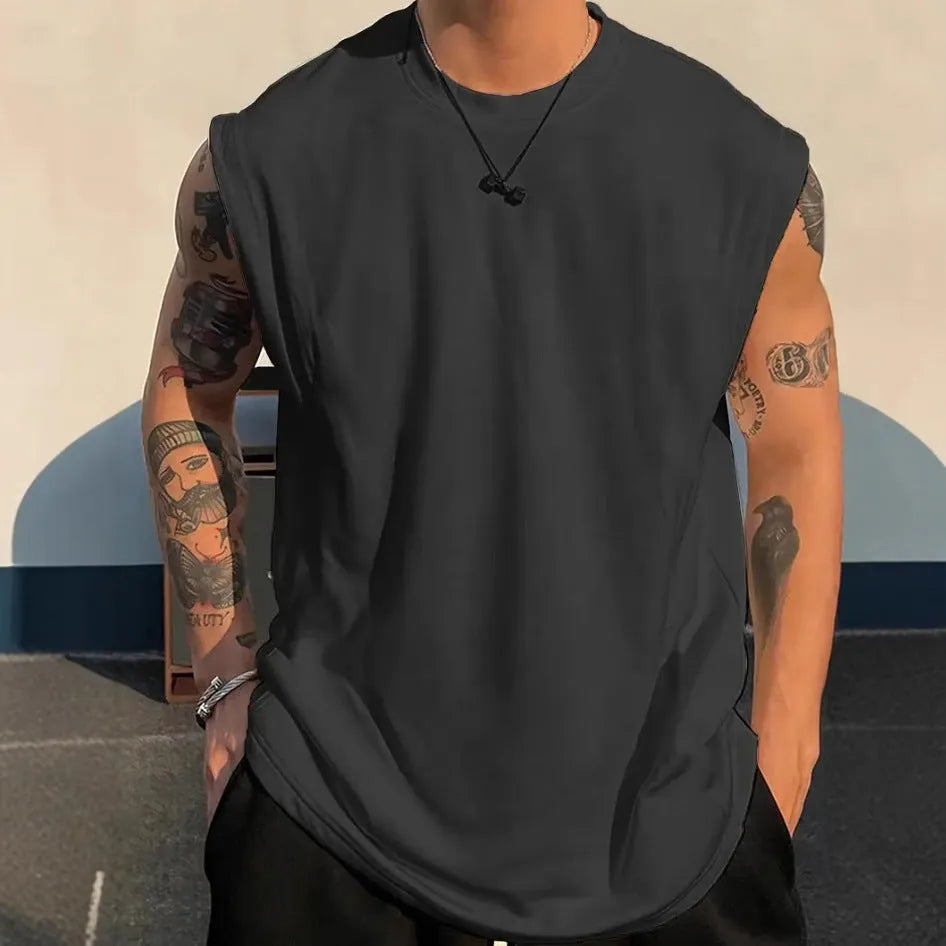 Men's loose solid colour sleeveless cotton tank top on a hanger, shown in a light apricot shade.