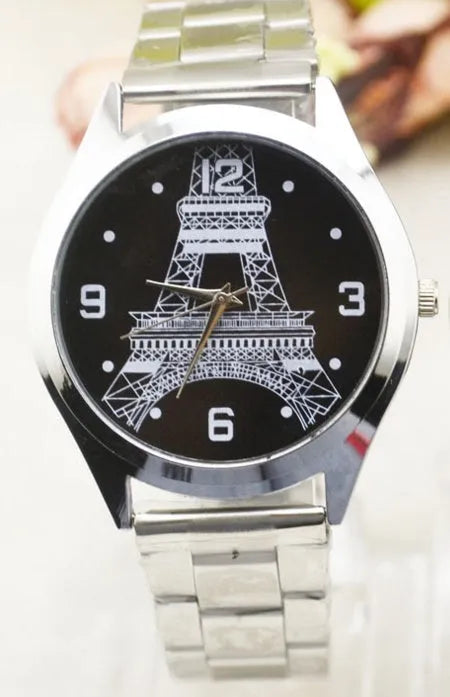 Black wrist watch with silver case and a dial featuring an Eiffel Tower design on a leather strap.