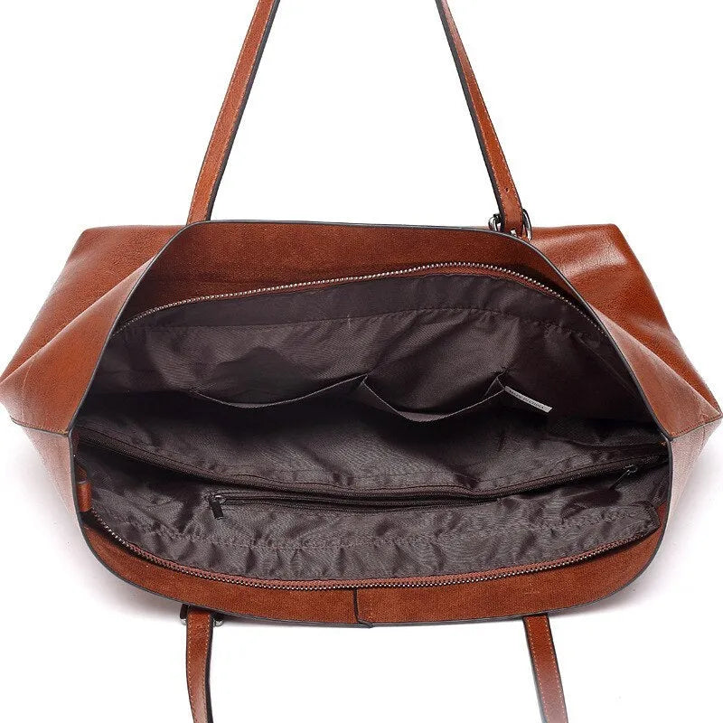 Brown wax cowhide leather handbag showing internal compartments and crossbody strap
