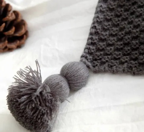 Nordic fringed knit ball acrylic blanket in beige colour on a sofa