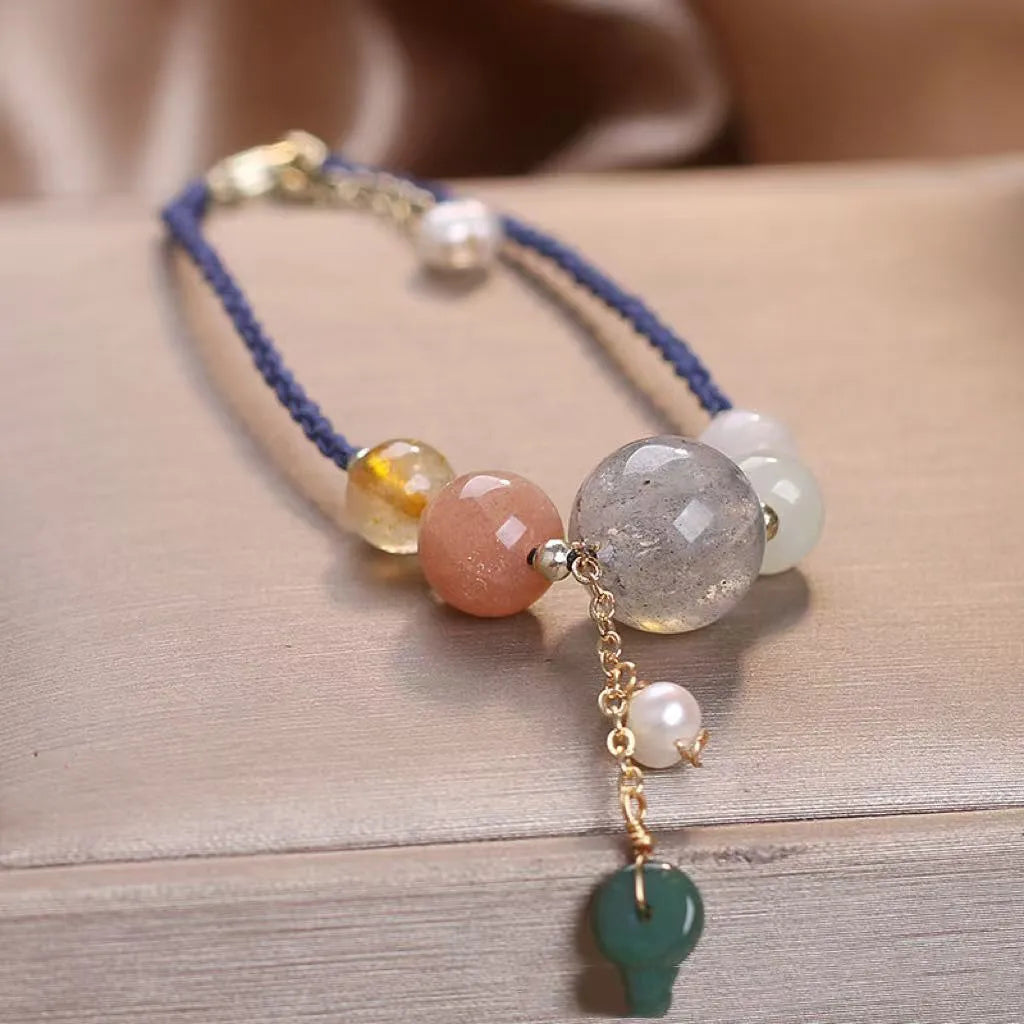 Peace buckle bracelet with crystal sequins on woven wrist string in blue, green, or red