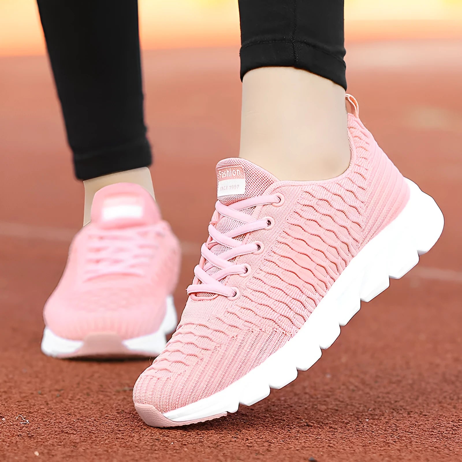 Women's running shoes with fly weave upper in Black, Pink, or White colours showing wear-resistant outsole