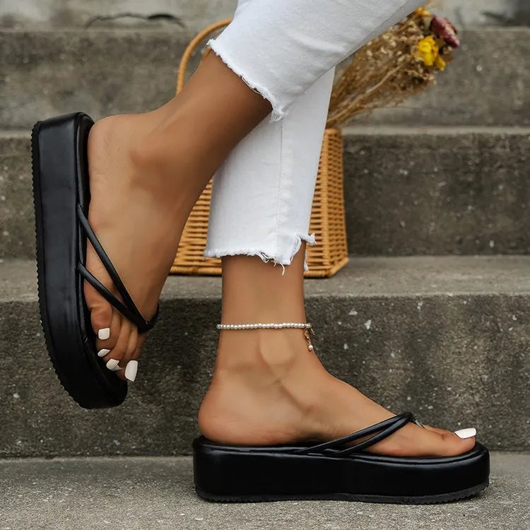 Thick-soled herringbone pattern flip-flops in multiple colours on a white background.