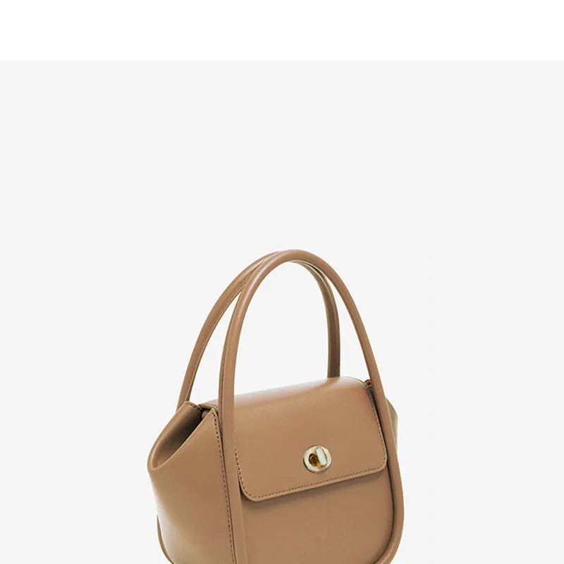Women's wing-shaped leather tote bag with latch closure and cross-body strap in four colour options
