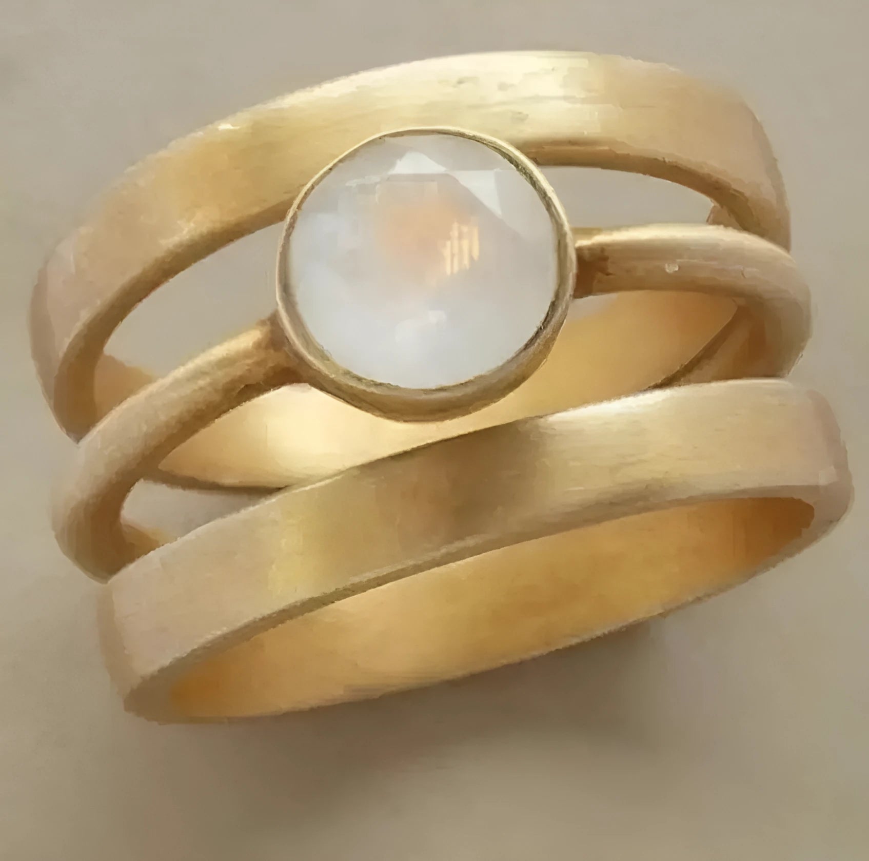 Gold-plated titanium steel ring with a white chalcedony stone in a geometric, micro-inlaid setting.
