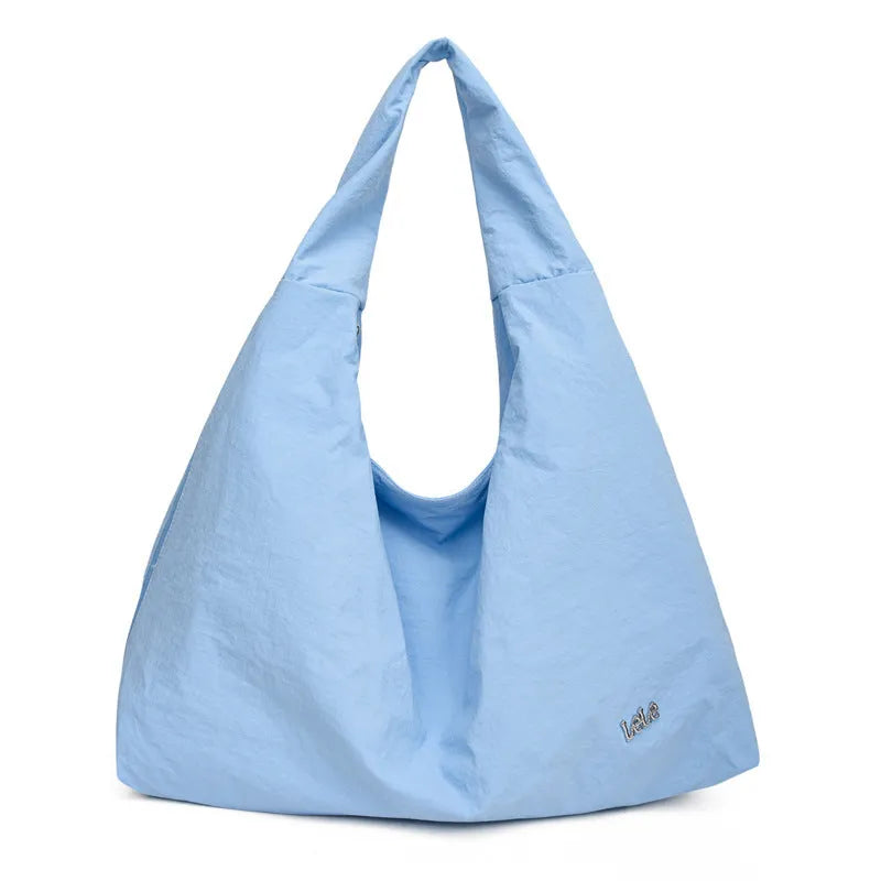 Nylon underarm bag with heart shape design in four colour options showing large capacity interior