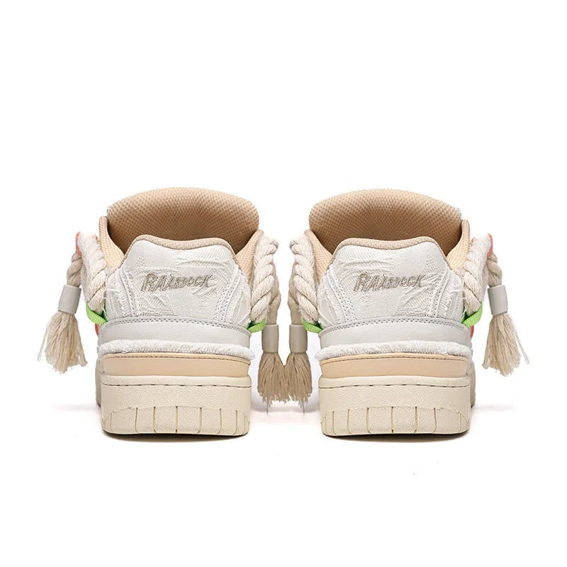 Creamy white retro low-top skate shoes with lace-up front and decorative stitching on a rubber sole.