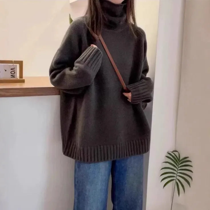 Women's loose thick turtleneck sweater with a textured 3D curling collar in a red solid colour.