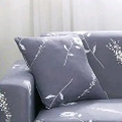 Geometric patterned stretch sofa slipcover fitted on a modern two-seater sofa.
