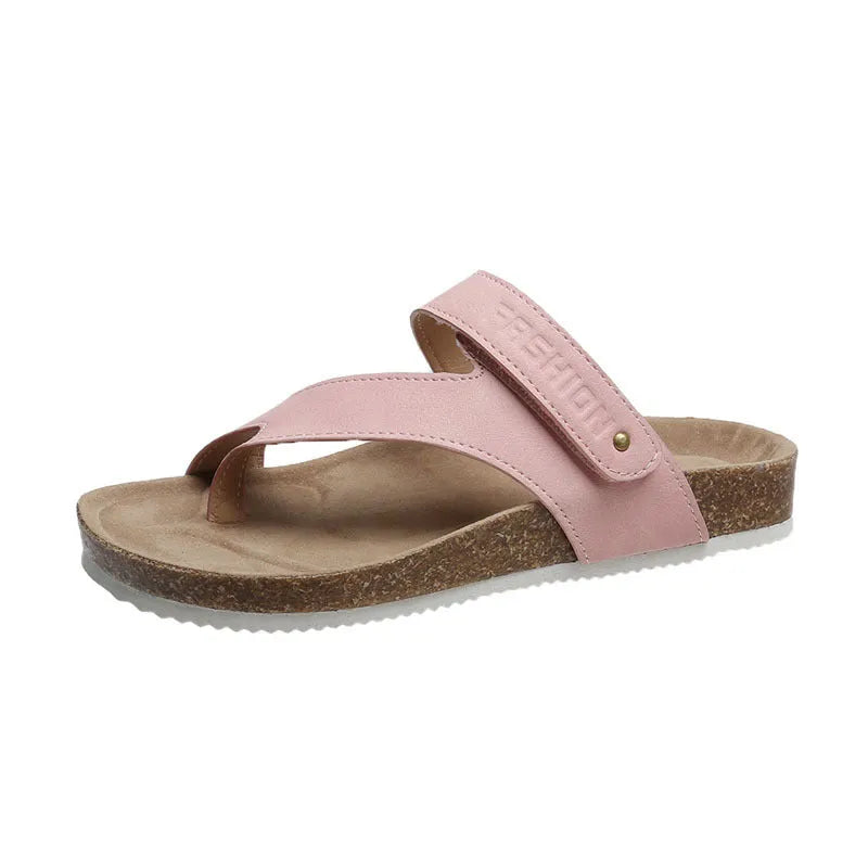 A pair of thick-soled flat toe ring flip-flops in a solid colour on a white background.
