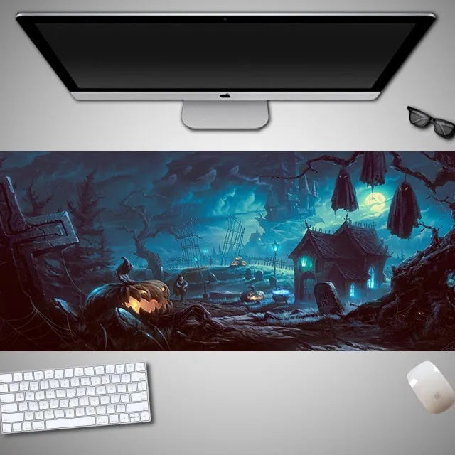 Oversized black Halloween-themed mouse pad with spooky artwork on a desk next to a gaming mouse.
