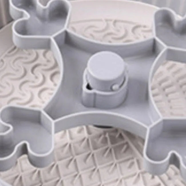Rotating pet food bowl with silicone slow feeder mat in blue with windmill pattern design
