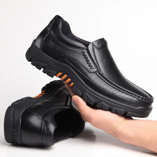 Men's black and brown cowhide leather business casual slip-on shoes with a rubber sole.