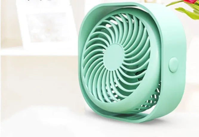 USB desk fan with rotating head in modern alarm clock design on desk