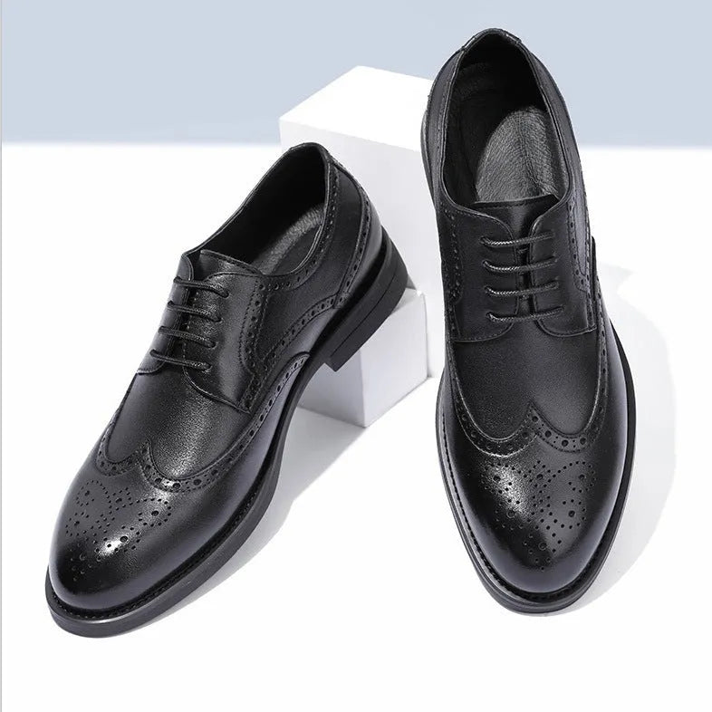 Men's black brogue leather shoes in a business style on a white background.