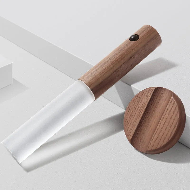 Smart sensor LED desk lamp in wood and acrylic glass on a desk.