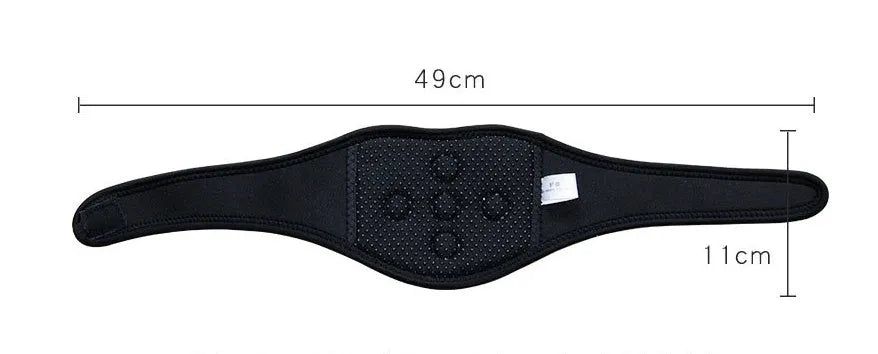Black self-heating magnetic therapy neck guard with adjustable strap on a flat surface.