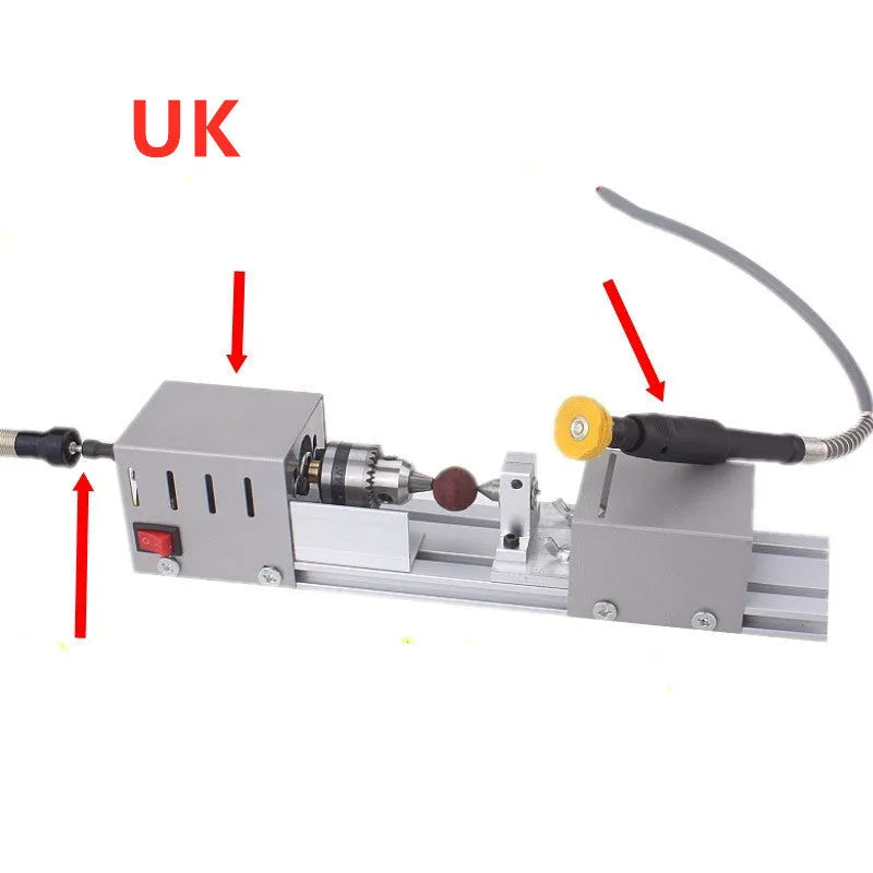 Mini silver metal manual woodworking lathe with carving knives on a workbench.