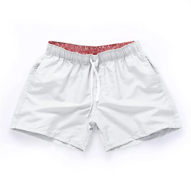 Men's straight-leg beach shorts in polyester, shown in a colour from the range including fluorescent yellow, black, or navy.