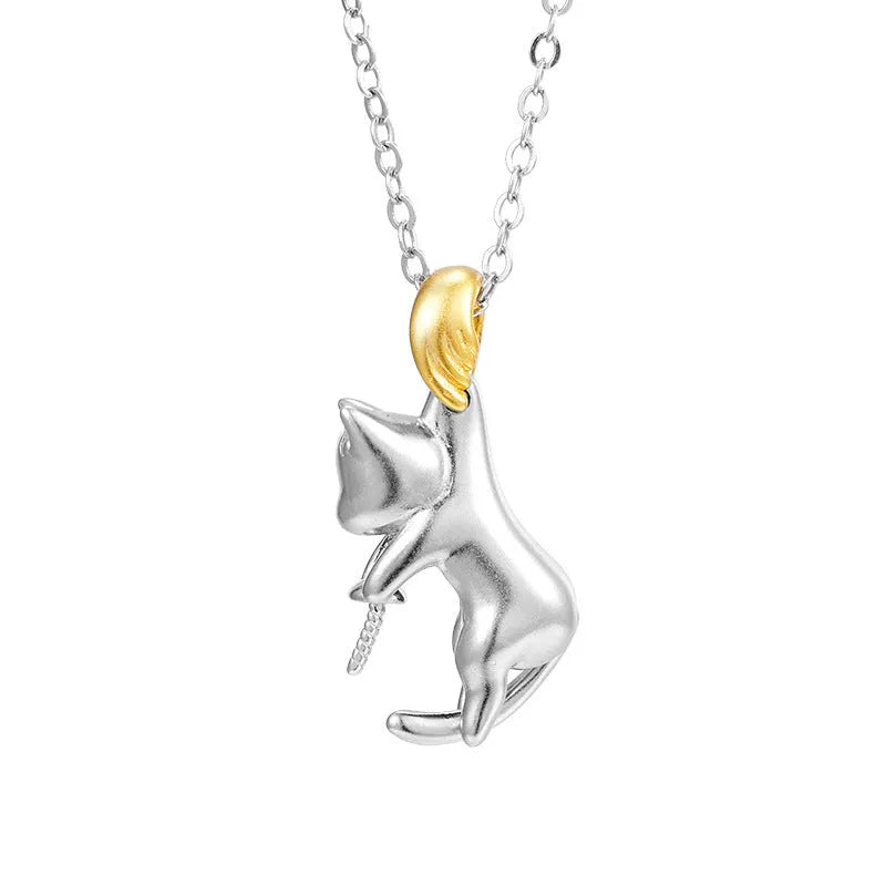 Close-up of a sterling silver cat charm clavicle chain necklace on a model.