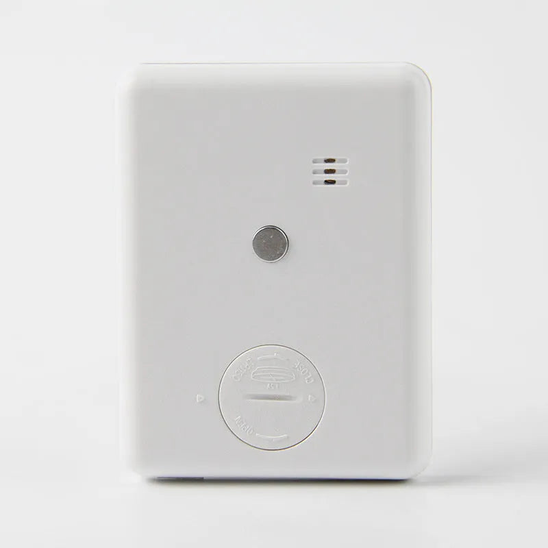 Black and white digital kitchen timer with magnetic back showing count up, countdown and alarm functions.