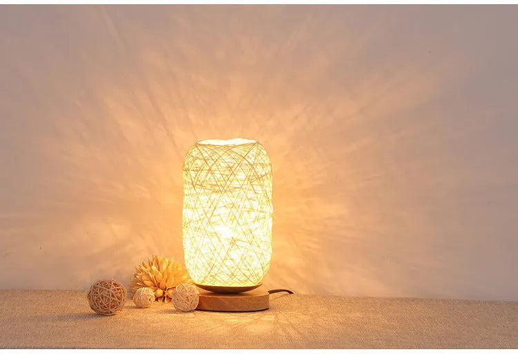Brown hemp rope Sepak Takraw ball desk lamp with solid wood base on a desk.