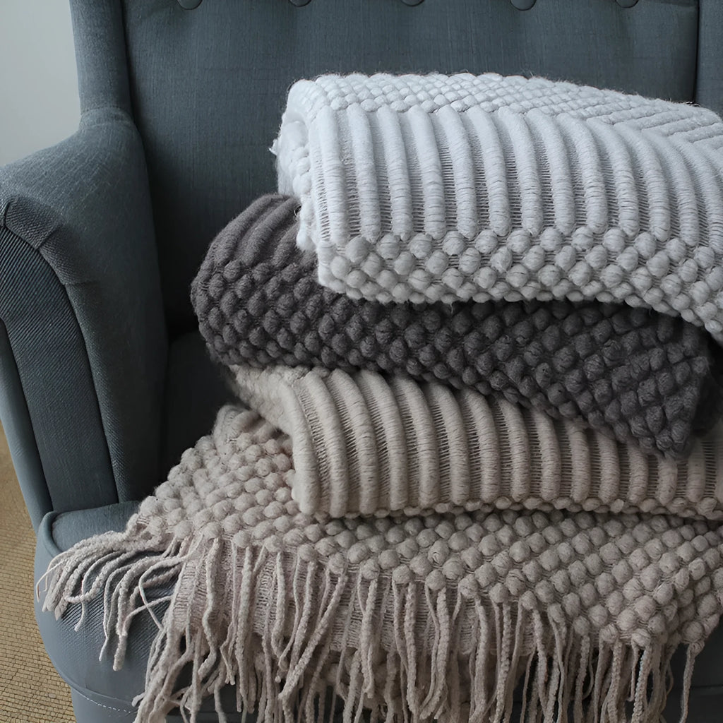 Small light grey polyester nap blanket folded, showing its 127x170cm size.