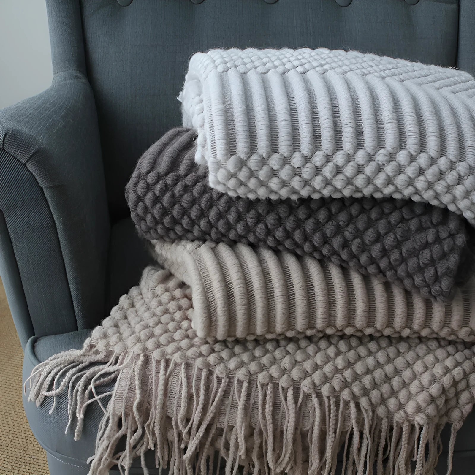 Small light grey polyester nap blanket folded, showing its 127x170cm size.