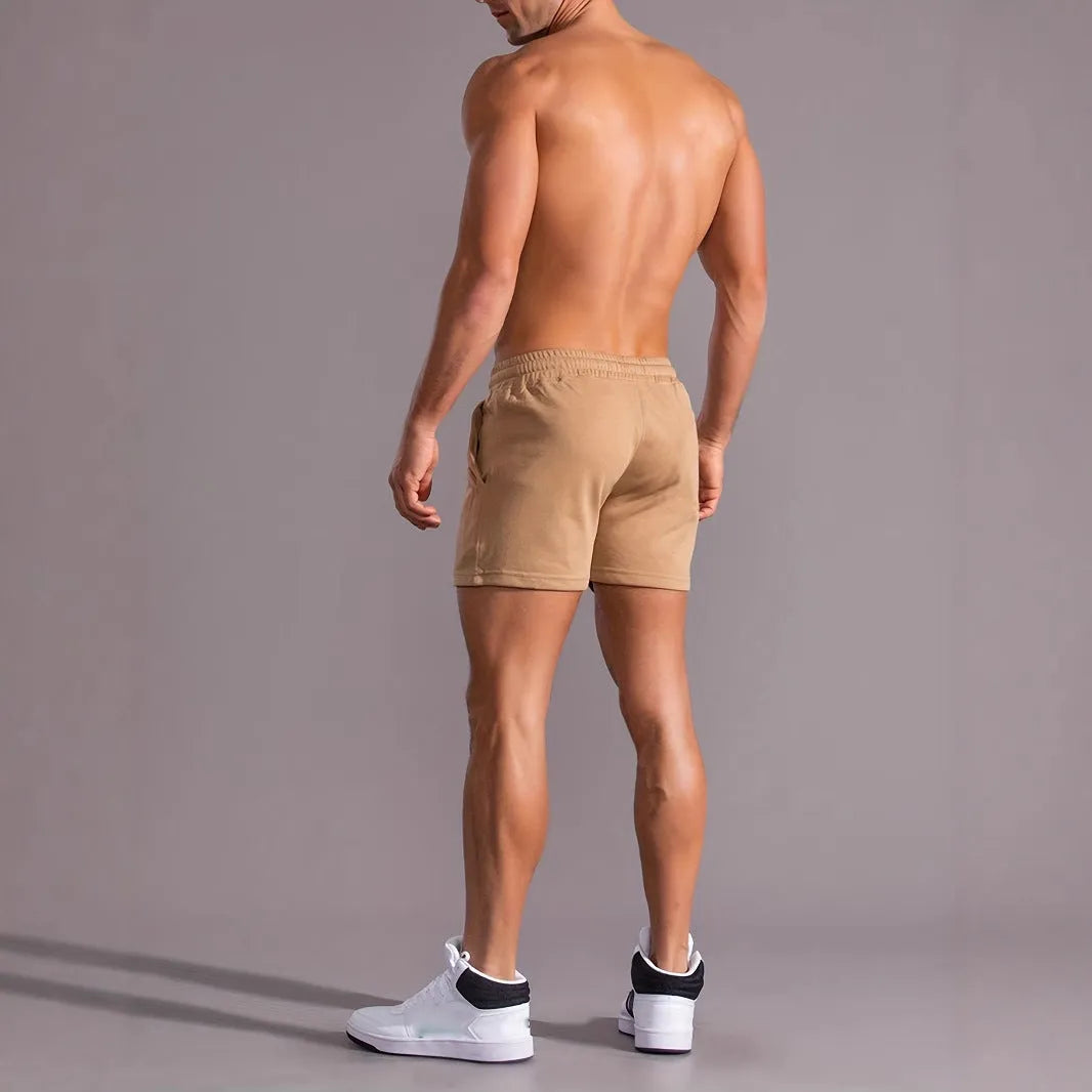 Khaki coloured men's sports shorts with coconut print design and straight cut for summer activities