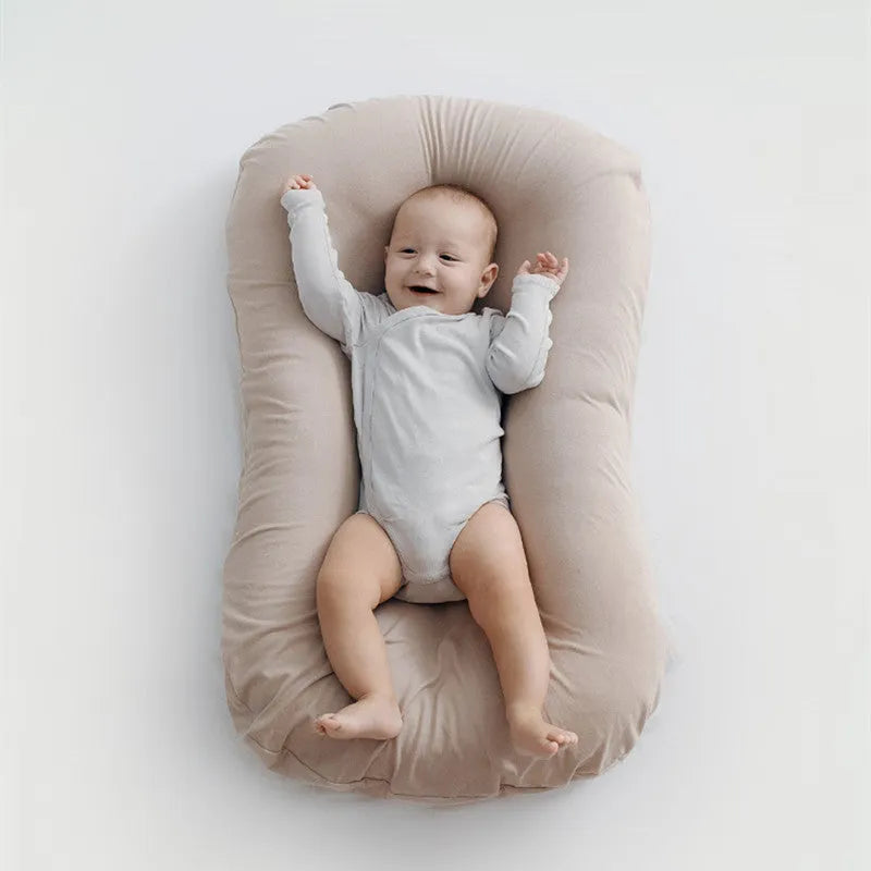 Beige portable cotton baby nest crib cushion measuring 75cm by 45cm for infant sleep.