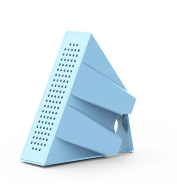 A small, coloured plastic phone amplifier holder holding a mobile phone on a desk.
