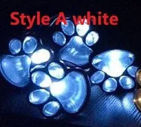 Black solar powered animal paw print LED garden lights set with four paw shapes and solar panel