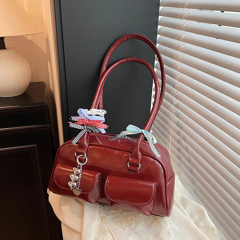 Retro pillow-shaped women's handbag in PU leather with double shoulder strap, shown in black colour