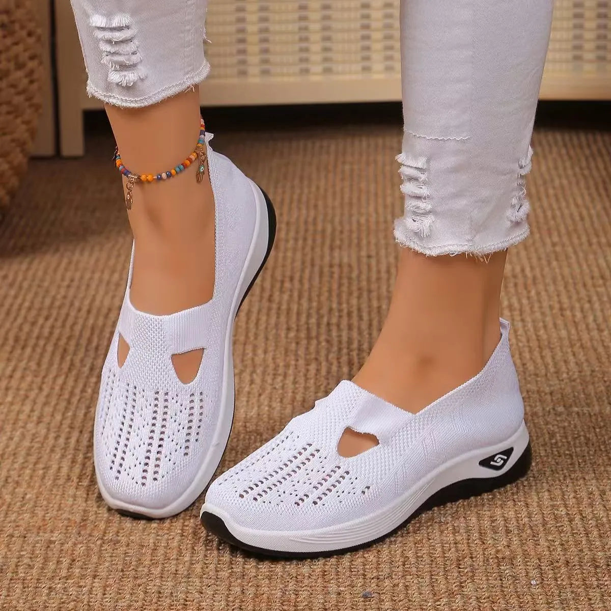 Women's black casual mesh shoes with T-strap and flat soft sole.
