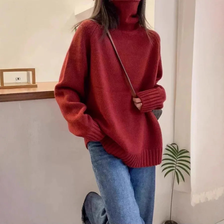 Women's loose thick turtleneck sweater with a textured 3D curling collar in a red solid colour.