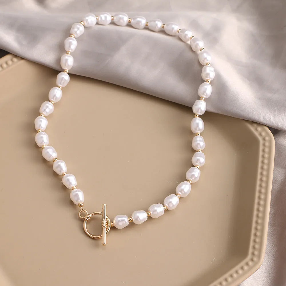 Vintage gold-tone heart pendant necklace with pearl chain and adjustable length