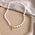 Vintage gold-tone heart pendant necklace with pearl chain and adjustable length