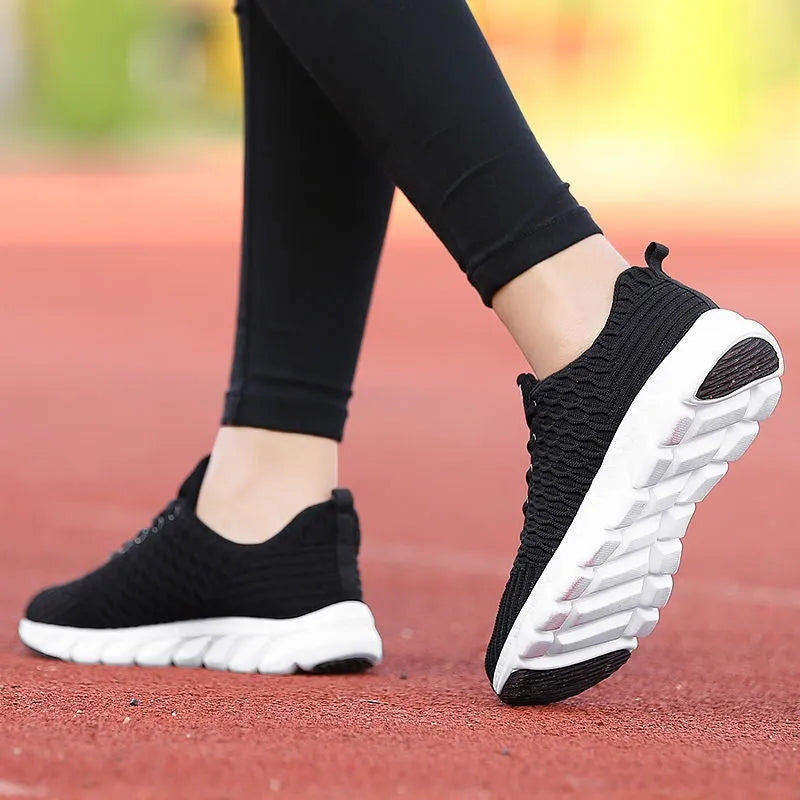 Women's running shoes with fly weave upper in Black, Pink, or White colours showing wear-resistant outsole