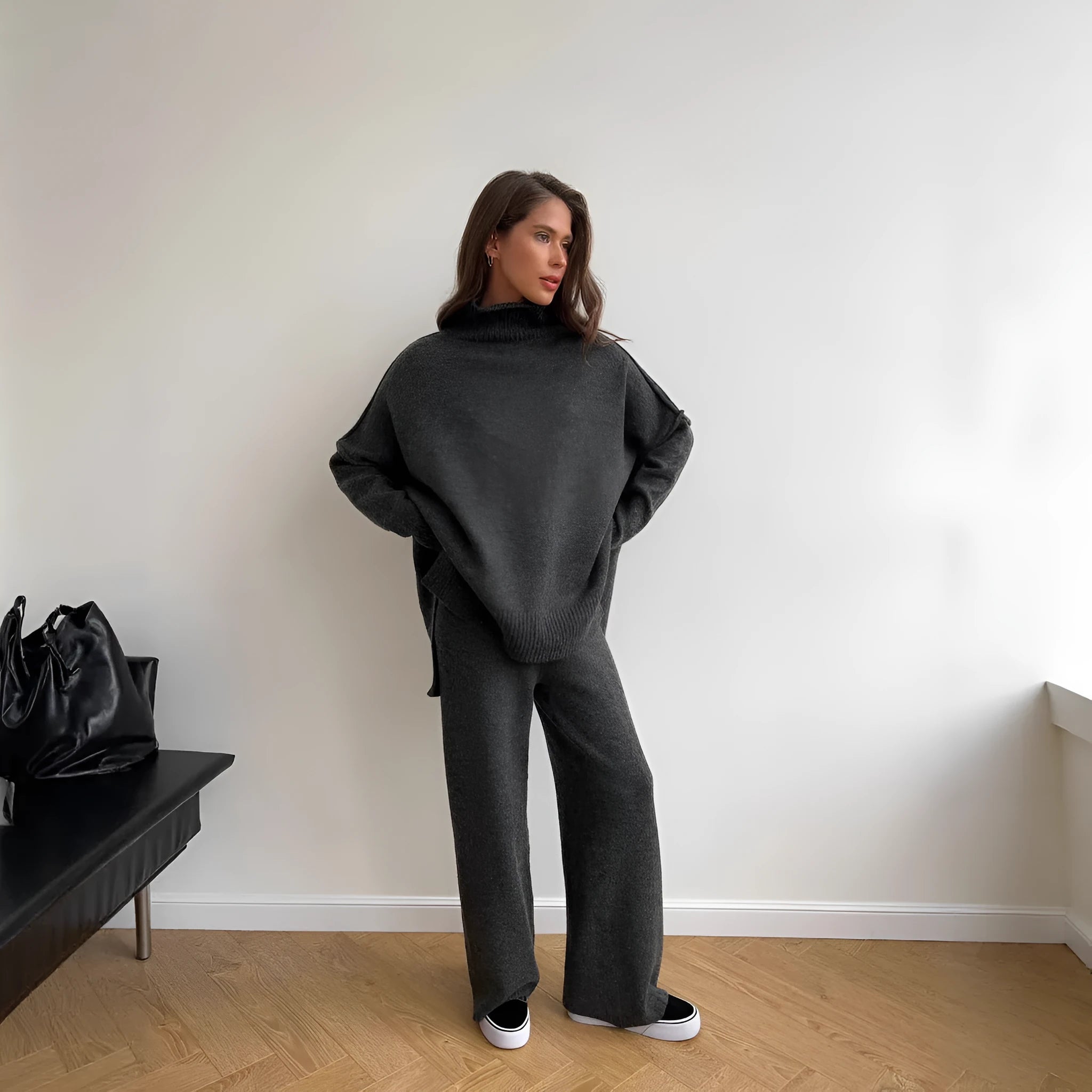 Women's dark grey acrylic sweater with side slits paired with matching trousers