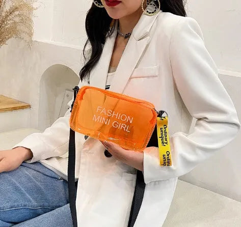 Transparent square women's shoulder bag in jelly material with a diagonal cross strap, showing internal mobile phone pocket.