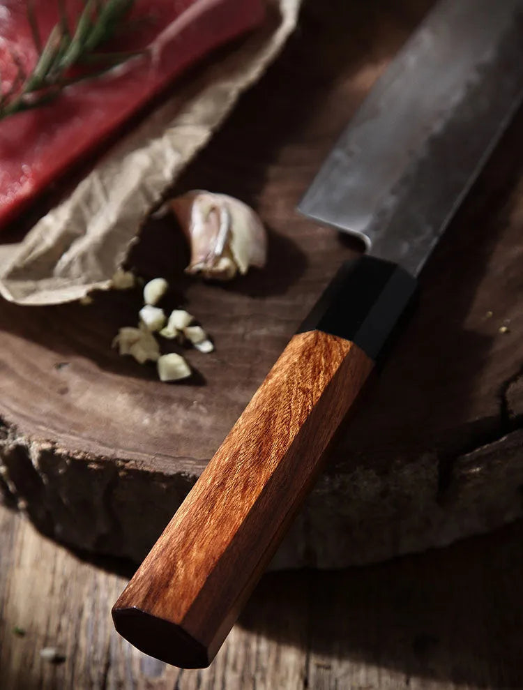 Hand forged Santoku chef knife with 149 cm silver blade on cutting board