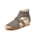 Women's beige patent leather flat sandals with a low wedge heel and back zipper closure