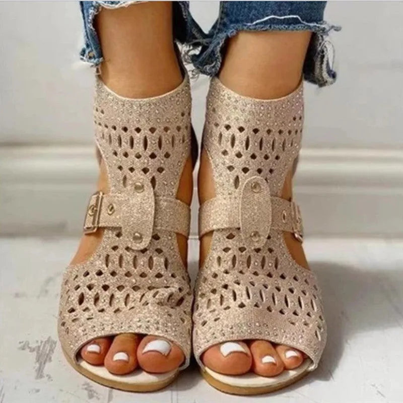 Women's beige patent leather flat sandals with a low wedge heel and back zipper closure