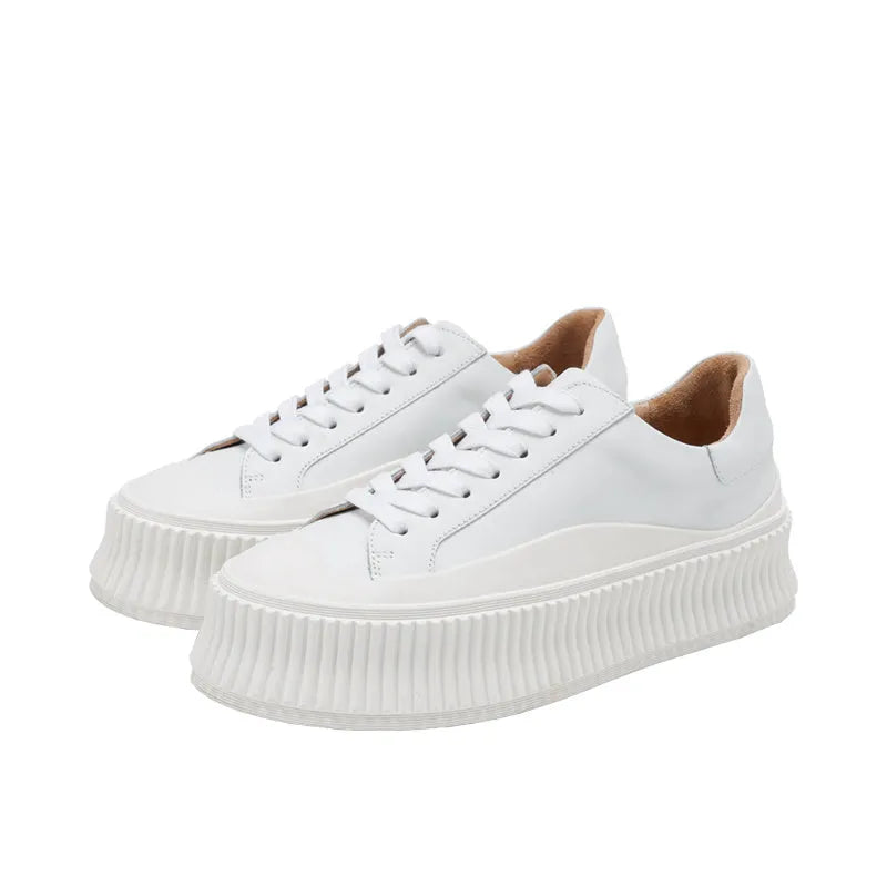 Women's black thick sole platform sneakers with back lacing system and suede leather construction