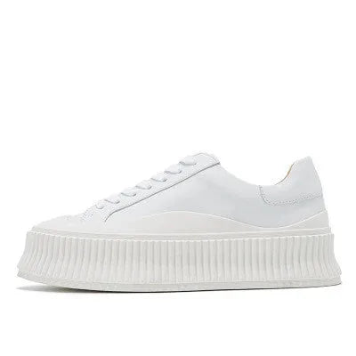 Women's black thick sole platform sneakers with back lacing system and suede leather construction