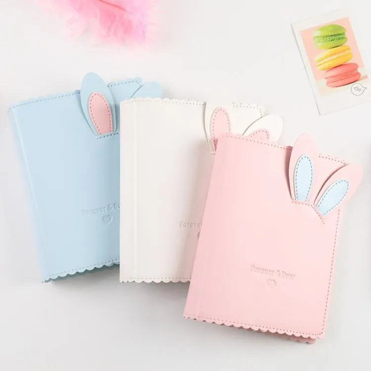 Cute bunny style mini photo album in pink, blue, or white, showing compact size and loose-leaf pages.