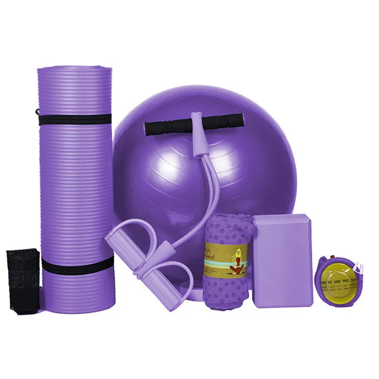 Five-piece beginner yoga set with purple mat, pink ball, tensioner, towel and brick