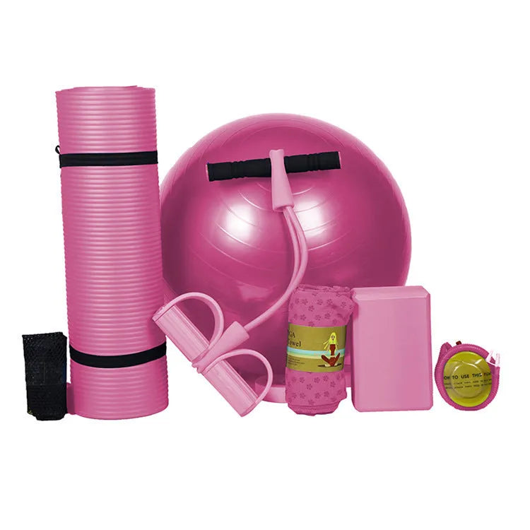 Five-piece beginner yoga set with purple mat, pink ball, tensioner, towel and brick