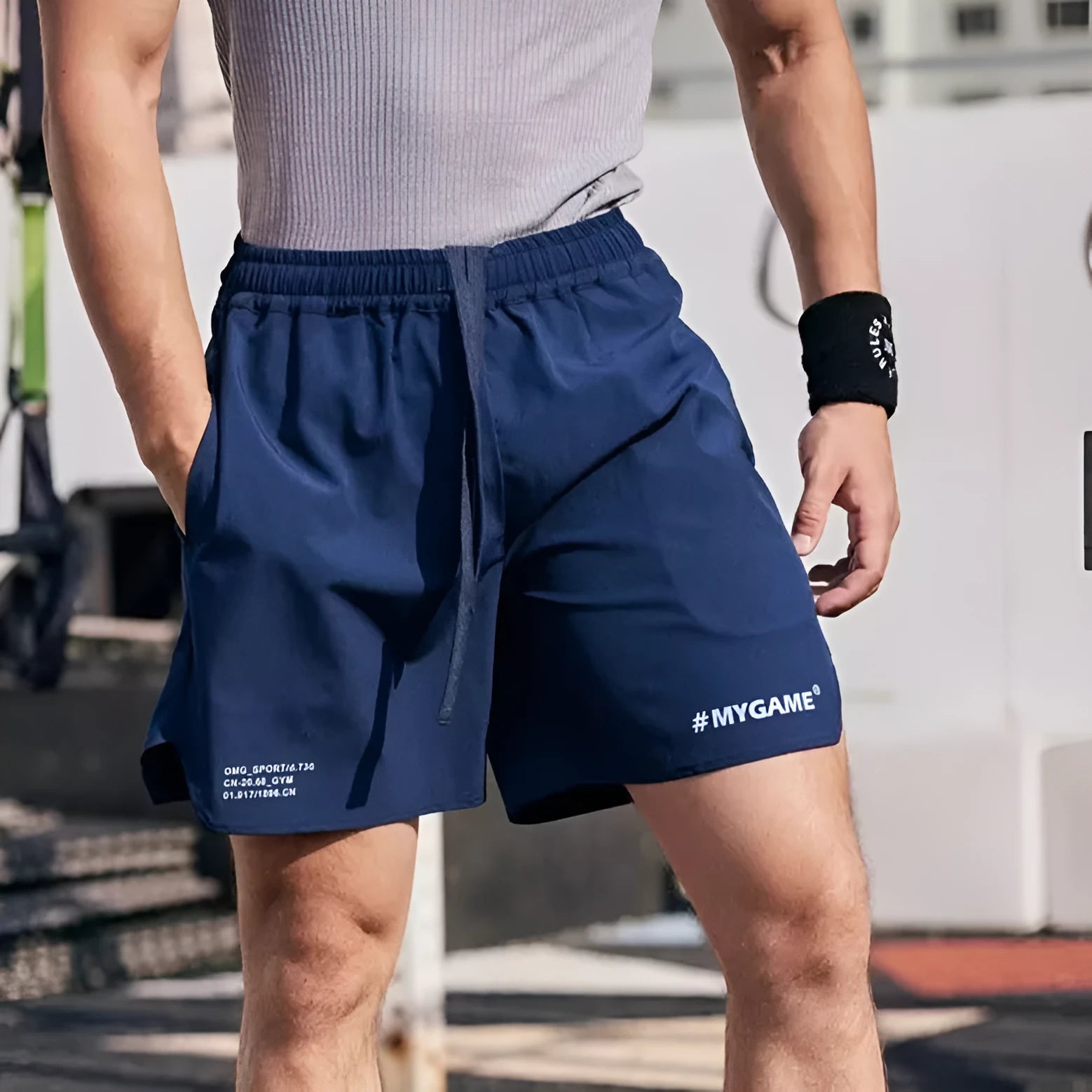 Men's grey quick-dry fitness training shorts made from polyester and spandex fabric.